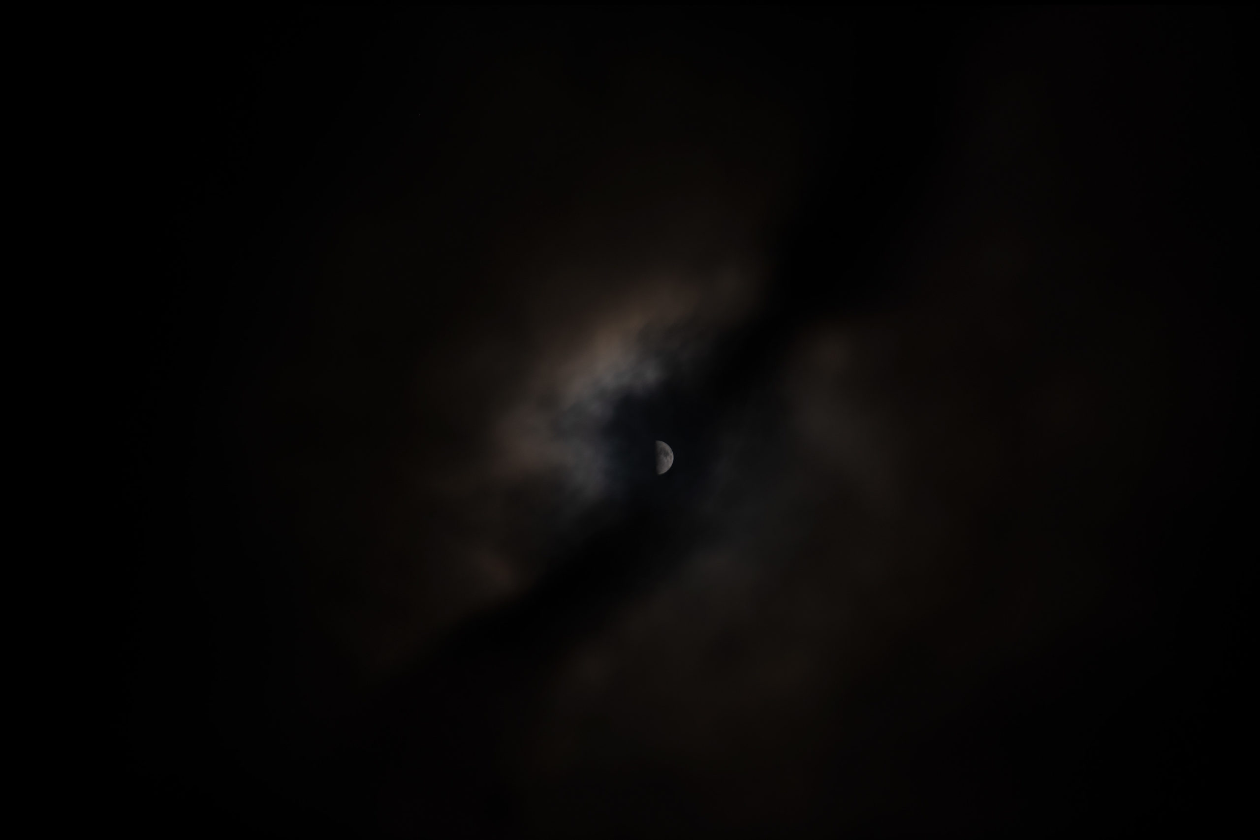 (Before Editing) Photo of the moon shining through clouds at night