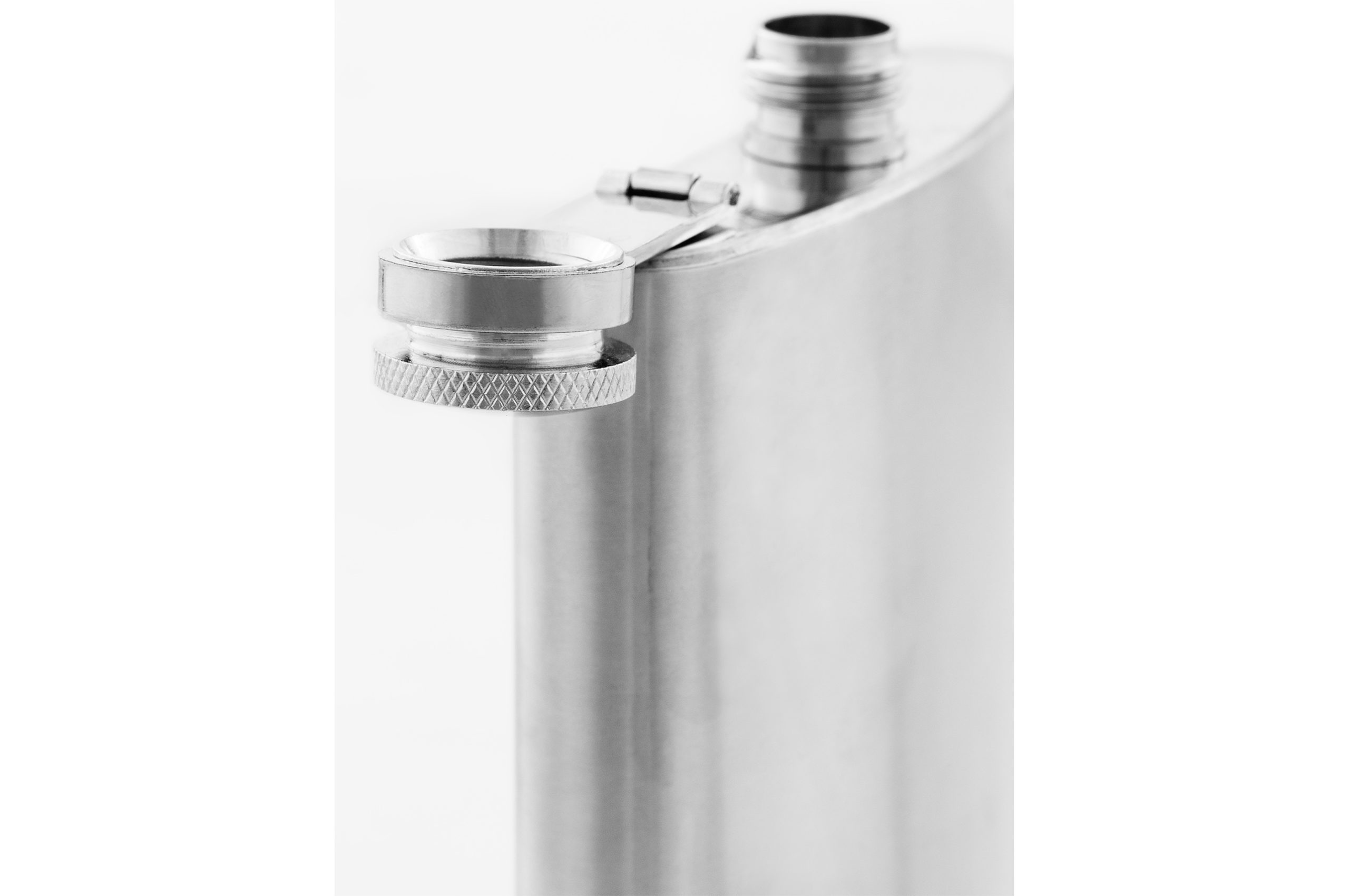close up still life photograph of silver coloured metallic flask