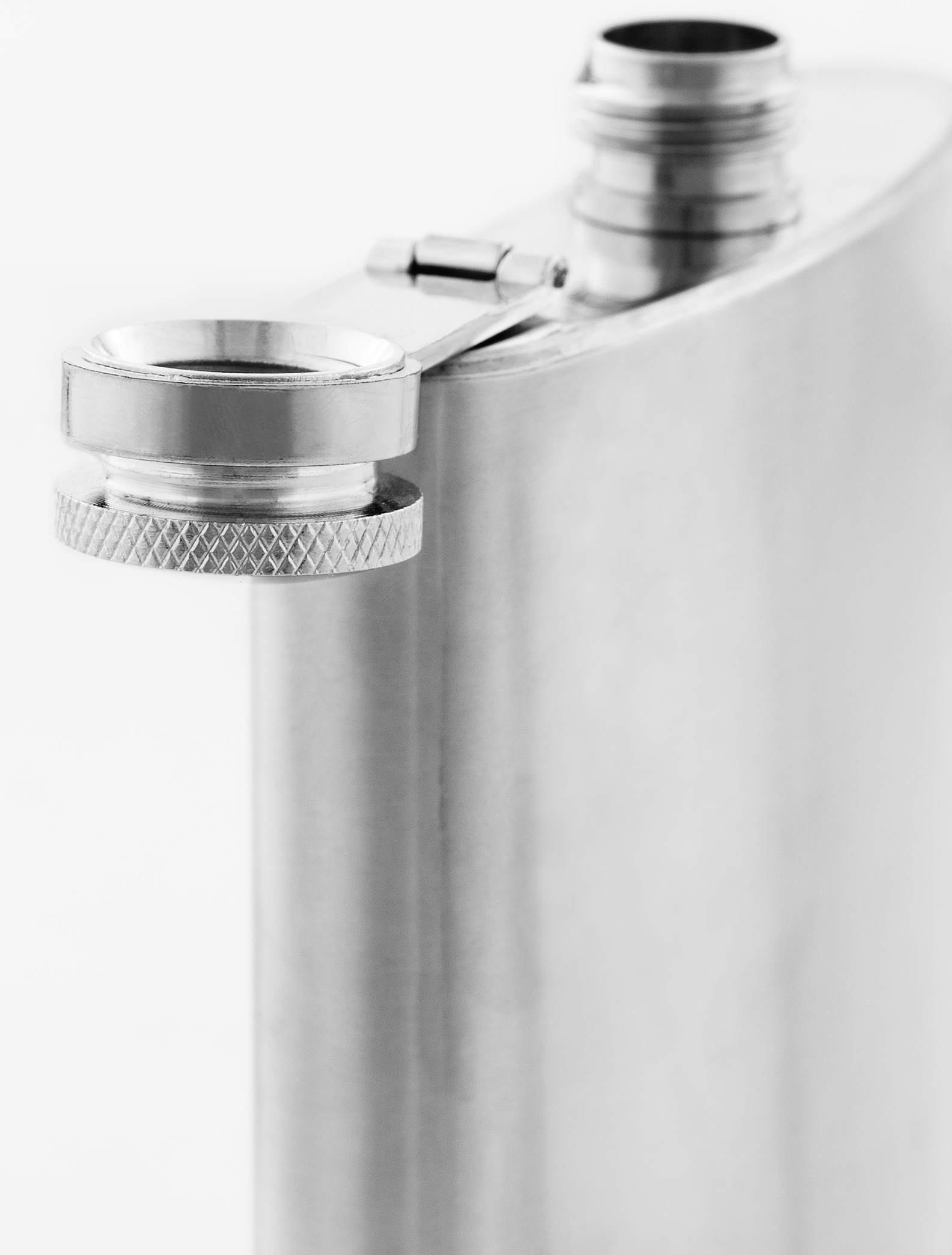 close up still life photograph of silver coloured metallic flask